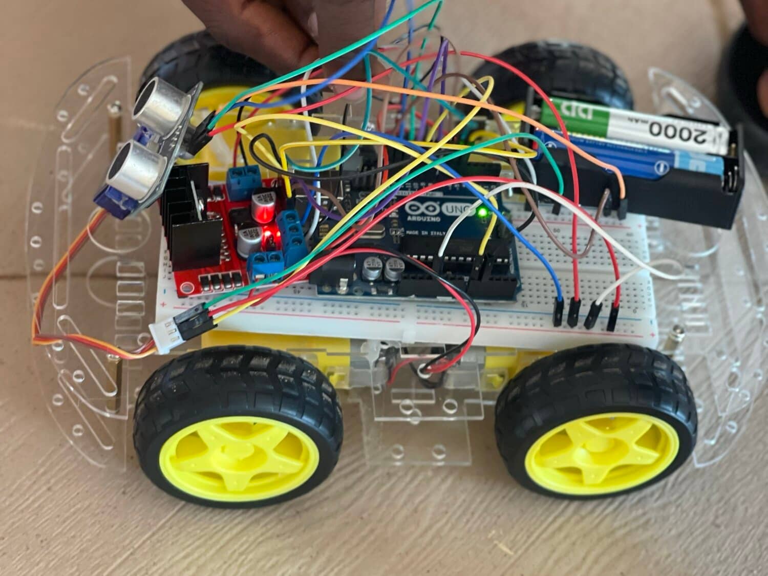 The Arduino, motor driver and ultrasonic sensor wired up on the breadboard for obstacle detection